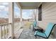 Relaxing front porch with two blue chairs and a small table overlooking the street at 823 Howard Ave., Myrtle Beach, SC 29577