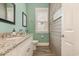 Stylish powder room with beadboard walls, wood look tile flooring and a white vanity with granite countertop at 823 Howard Ave., Myrtle Beach, SC 29577