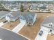 Aerial view showcasing the home's facade, landscaping, and surrounding neighborhood at 860 Saluda River Rd., Myrtle Beach, SC 29588