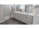 Bright bathroom featuring double vanity, quartz countertops, and a glass-enclosed shower with marble tiling at 860 Saluda River Rd., Myrtle Beach, SC 29588