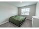 Neutral bedroom featuring a twin bed with gray carpet and bright window at 860 Saluda River Rd., Myrtle Beach, SC 29588