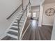 Bright entryway featuring wood floors, staircase, and modern design elements at 860 Saluda River Rd., Myrtle Beach, SC 29588