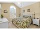 Bright bedroom featuring a large arched window, a ceiling fan, and a cozy bed with a leafy patterned comforter at 862 Edgewater Dr., Murrells Inlet, SC 29576