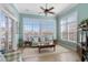 Bright living room featuring a wall of windows overlooking a serene lake view and stylish furnishings at 862 Edgewater Dr., Murrells Inlet, SC 29576