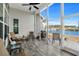 Relaxing screened porch with lake views, outdoor seating, and a ceiling fan at 862 Edgewater Dr., Murrells Inlet, SC 29576