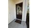 Elegant front door featuring a glass pane, decorative wreath, and a welcoming 'home' doormat at 88 Pinnacle Dr., Murrells Inlet, SC 29576