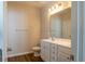 Well-lit bathroom featuring a white vanity, toilet, and wood-look flooring at 92 Costa Ct., Pawleys Island, SC 29585