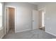 Carpeted bedroom featuring multiple doorways, closet and light-filled window at 92 Costa Ct., Pawleys Island, SC 29585