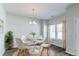 Bright dining room with large window and modern chandelier at 92 Costa Ct., Pawleys Island, SC 29585