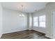 Bright dining room featuring hardwood floors, a modern chandelier, and natural light from windows at 92 Costa Ct., Pawleys Island, SC 29585