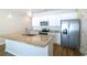 Modern kitchen island features granite countertops, white cabinets, and stainless steel appliances at 92 Costa Ct., Pawleys Island, SC 29585