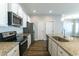 Modern kitchen features white cabinets, stainless steel appliances, granite countertops, and a kitchen island at 92 Costa Ct., Pawleys Island, SC 29585