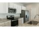 Modern kitchen features white cabinets, stainless steel appliances, and granite countertops at 92 Costa Ct., Pawleys Island, SC 29585