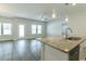 Open floor plan with a kitchen island, stainless steel appliances, and a sliding glass door to the backyard at 92 Costa Ct., Pawleys Island, SC 29585