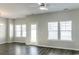 Bright living room with hardwood floors, ceiling fan, and natural light from multiple windows at 92 Costa Ct., Pawleys Island, SC 29585