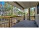 Covered back porch with a wooden railing provides a relaxing outdoor space at 935 Little Creek Rd., Myrtle Beach, SC 29572