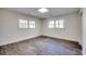 Bright bedroom featuring two windows and wood-look flooring at 935 Little Creek Rd., Myrtle Beach, SC 29572