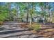 Exterior view of the home with a connected carport and tree lined driveway at 935 Little Creek Rd., Myrtle Beach, SC 29572