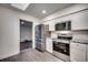 Well-lit kitchen with stainless steel appliances, white cabinetry, and updated countertops at 935 Little Creek Rd., Myrtle Beach, SC 29572