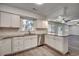 Corner view of kitchen with white cabinets, stainless steel appliances, and hardwood-style floors at 935 Little Creek Rd., Myrtle Beach, SC 29572