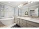 Elegant bathroom with freestanding tub, dual sinks, marble countertops, and plantation shutters at 938 Wallace Pate Dr., Georgetown, SC 29440