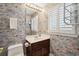 Quaint half bathroom with playful wallpaper, dark vanity, and window with plantation shutters at 938 Wallace Pate Dr., Georgetown, SC 29440