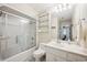 Bright bathroom features a shower-tub combo with vanity and decorative shelving at 938 Wallace Pate Dr., Georgetown, SC 29440