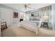 Cozy bedroom with white bedding, blue accents, rocking chair, and plantation shutters at 938 Wallace Pate Dr., Georgetown, SC 29440