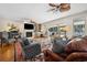 Bright living room with a fireplace, a piano, and a sliding glass door leading to an outdoor patio at 938 Wallace Pate Dr., Georgetown, SC 29440