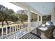 Outdoor porch showcases comfortable seating with white pillars and view of the outdoor landscaping at 938 Wallace Pate Dr., Georgetown, SC 29440