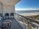 Enjoy the beautiful ocean views from the cozy seating area on this charming condo's private balcony at 9820 Queensway Blvd. # 706, Myrtle Beach, SC 29572