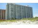 View of the multi-story condo from the beach showcasing its many balconies and beach access at 9820 Queensway Blvd. # 706, Myrtle Beach, SC 29572