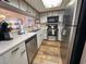 A well-lit kitchen with stainless steel appliances, white cabinets and views to the living room at 9820 Queensway Blvd. # 706, Myrtle Beach, SC 29572