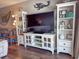 Cozy living room space with television, storage, and ocean themed decor at 9820 Queensway Blvd. # 706, Myrtle Beach, SC 29572