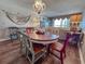 Comfortable dining area flowing into the living room with a large decorative chandelier at 9820 Queensway Blvd. # 706, Myrtle Beach, SC 29572