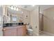 This bathroom features a vanity with a black countertop, a toilet, and a shower with glass doors at 9994 Beach Club Dr. # 2408, Myrtle Beach, SC 29572