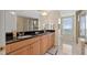 Bright bathroom featuring double sinks, wood cabinets and a glass shower at 9994 Beach Club Dr. # 2408, Myrtle Beach, SC 29572