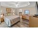 Comfortable main bedroom with en suite bath, with a tray ceiling and ceiling fan at 9994 Beach Club Dr. # 2408, Myrtle Beach, SC 29572