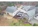 Aerial showing home's spacious outdoor entertainment areas, including deck, patio, and lush landscaping at 1 Sun Ct., Carolina Shores, NC 28467