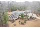 Aerial view of a home nestled among trees showcasing its extensive landscaping and outdoor features at 1 Sun Ct., Carolina Shores, NC 28467