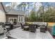 Outdoor deck featuring comfortable seating, a grill, and a serene view of the wooded backyard at 1 Sun Ct., Carolina Shores, NC 28467