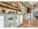 Stylish bar area with lighted cabinets, granite countertops, and a view to the adjoining rooms at 1 Sun Ct., Carolina Shores, NC 28467