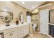 Bathroom featuring tile floors, dual sinks, and a framed mirror at 1 Sun Ct., Carolina Shores, NC 28467