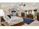 Large primary bedroom with sitting area, wood furniture, and natural light at 1 Sun Ct., Carolina Shores, NC 28467