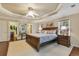 Spacious primary bedroom featuring trey ceiling, ceiling fan, and ensuite access at 1 Sun Ct., Carolina Shores, NC 28467