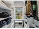Walk-in closet features custom shelving, storage space, and a window bringing in natural light at 1 Sun Ct., Carolina Shores, NC 28467