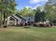 Charming home featuring stone accents, beautiful landscaping, and a welcoming front yard at 1 Sun Ct., Carolina Shores, NC 28467