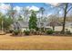 A beautiful home featuring mature trees, pretty landscaping, and a comfortable front porch at 1 Sun Ct., Carolina Shores, NC 28467