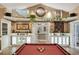 Open game room with custom-built bar, billiards table, and access to other living areas of the home at 1 Sun Ct., Carolina Shores, NC 28467