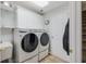 Laundry room boasts modern washer and dryer, storage cabinets, and access to the outside at 1 Sun Ct., Carolina Shores, NC 28467